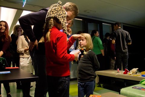 Kid with penguin in hand and Cheeta Headset on